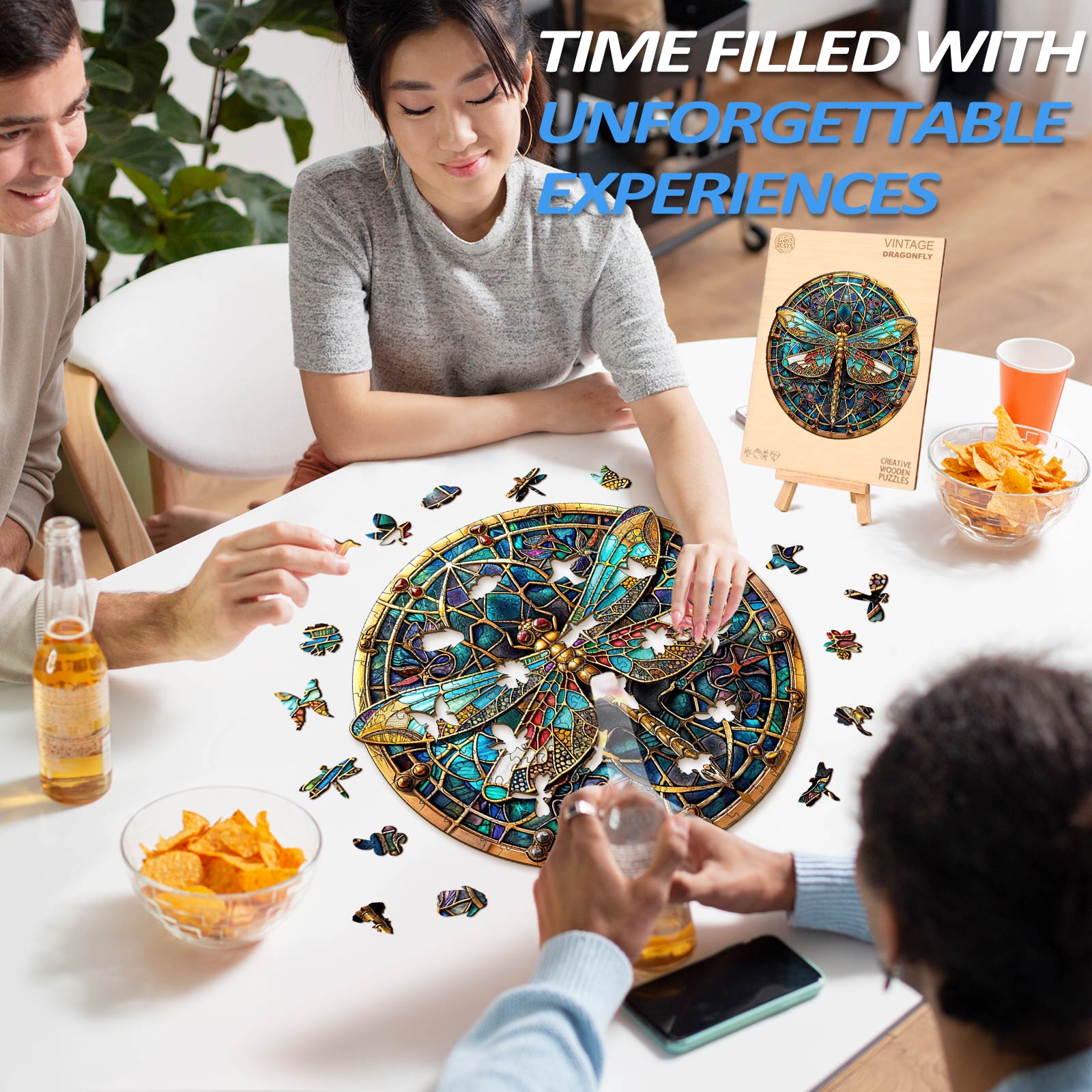 Group enjoying the Vintage Dragonfly Wooden Jigsaw Puzzle while sharing drinks and snacks.