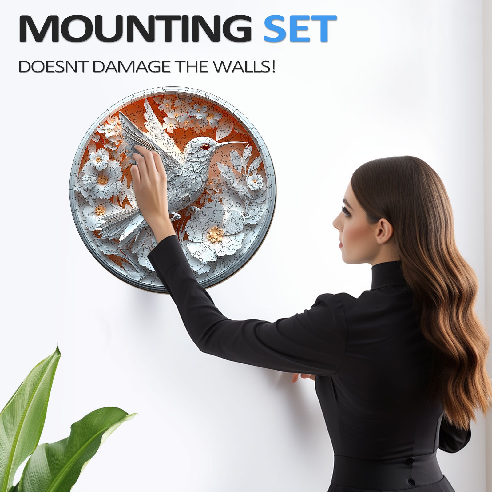 Woman using a wall mounting set for a decorative round bird artwork, ensuring no wall damage.