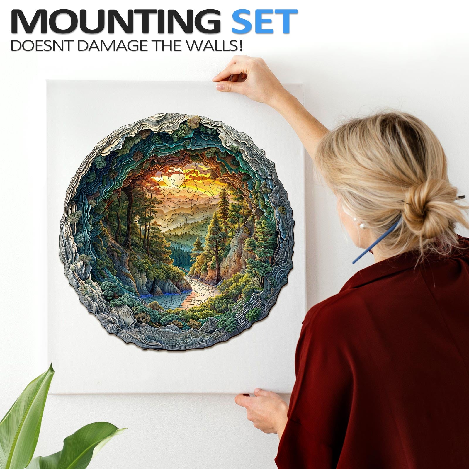 Person mounting a 3D cave forest jigsaw puzzle on the wall, showcasing its vibrant colors and intricate design.