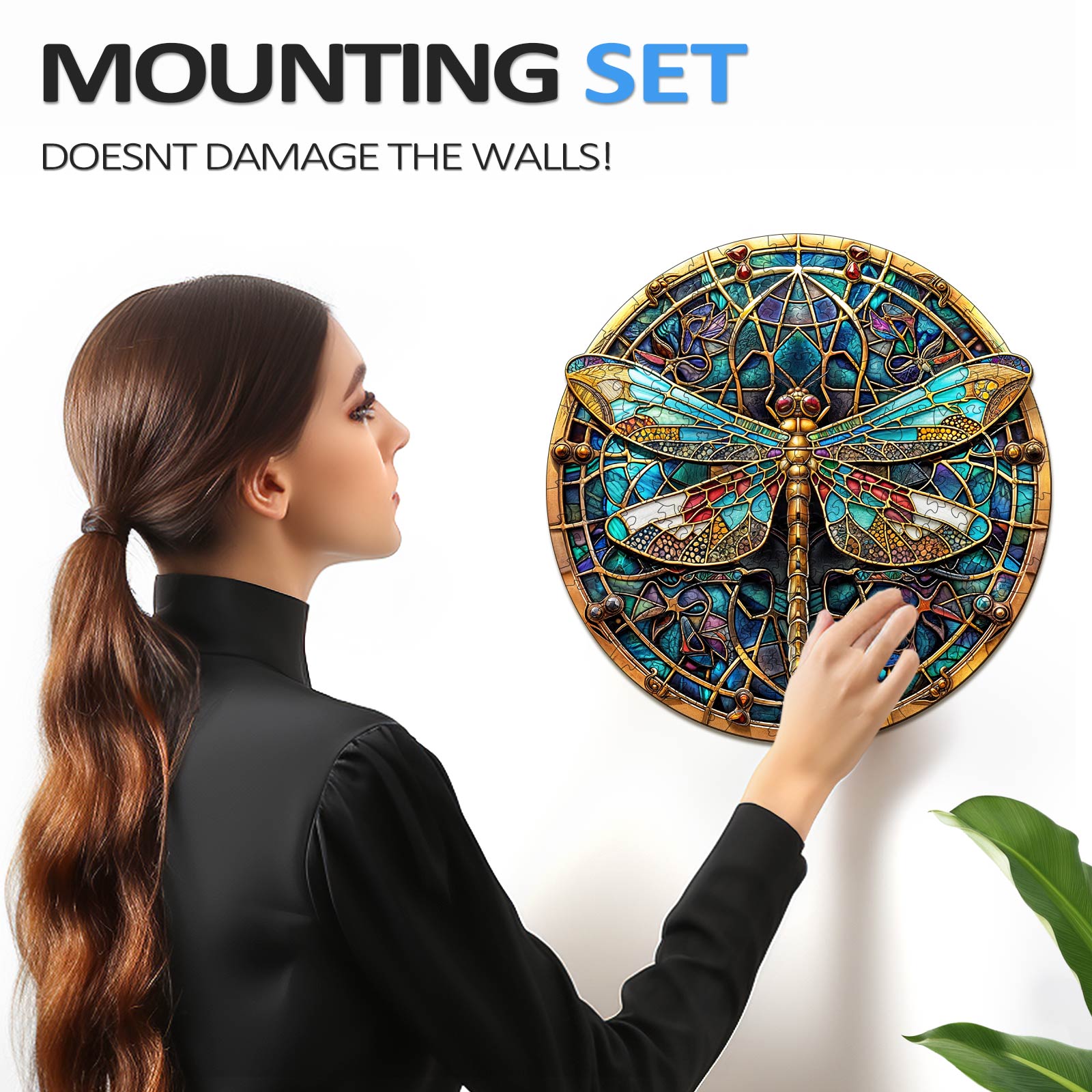 A person installing a Vintage Dragonfly wall art puzzle with a mounting set that doesn't damage walls.