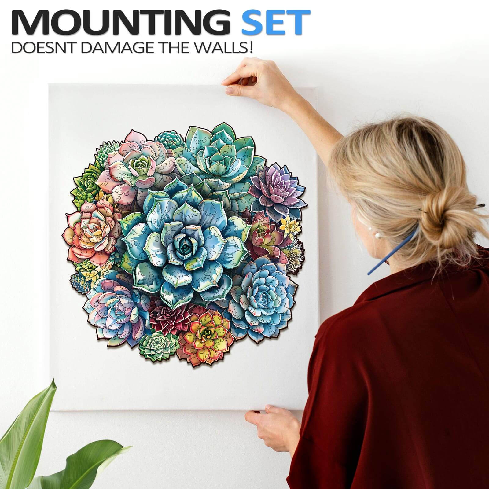 Woman holding Elegant Succulent Wooden Jigsaw Puzzle, showcasing vibrant colors and unique design for home decor.