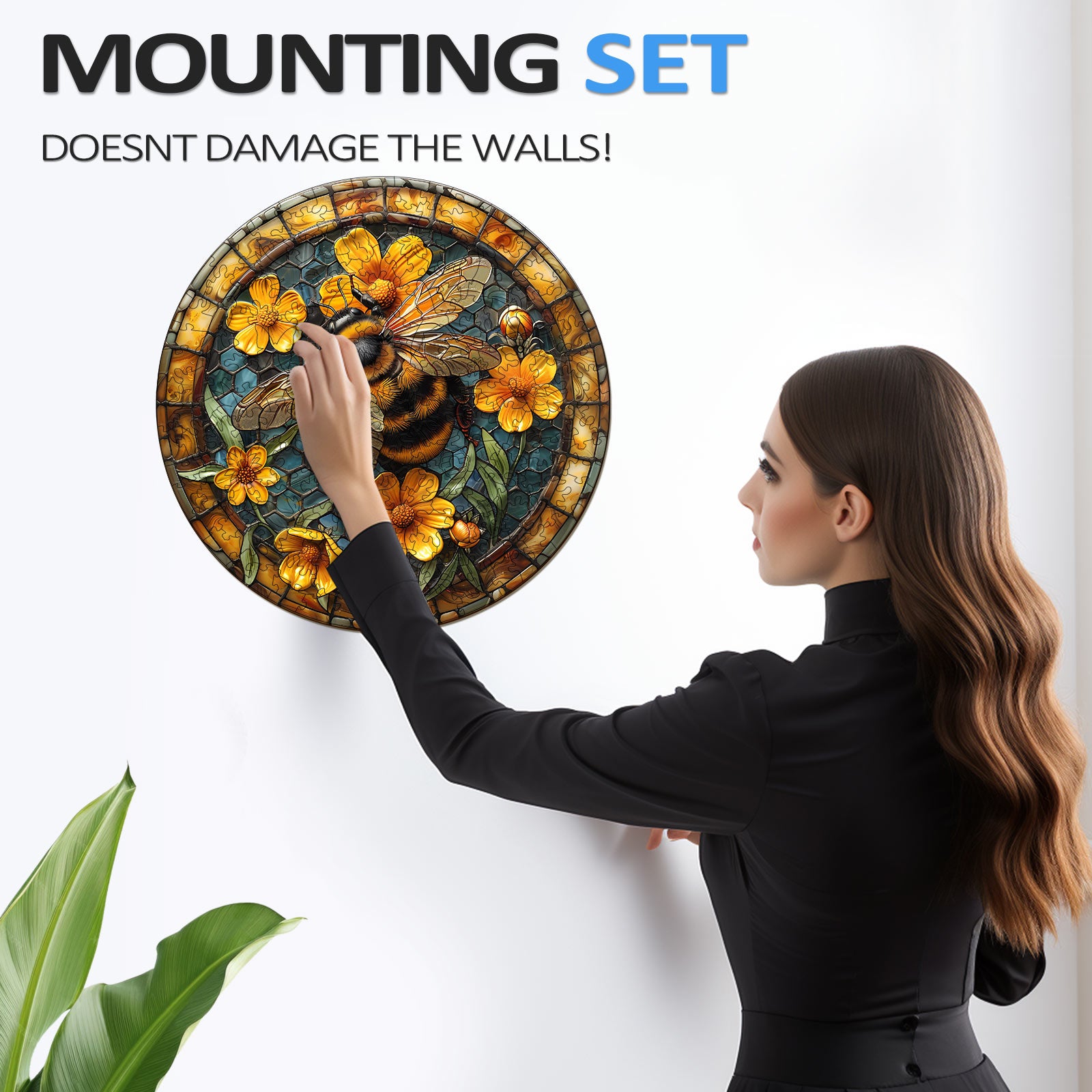 Woman installing a stained glass wall decor with mounting set that doesn't damage the walls.