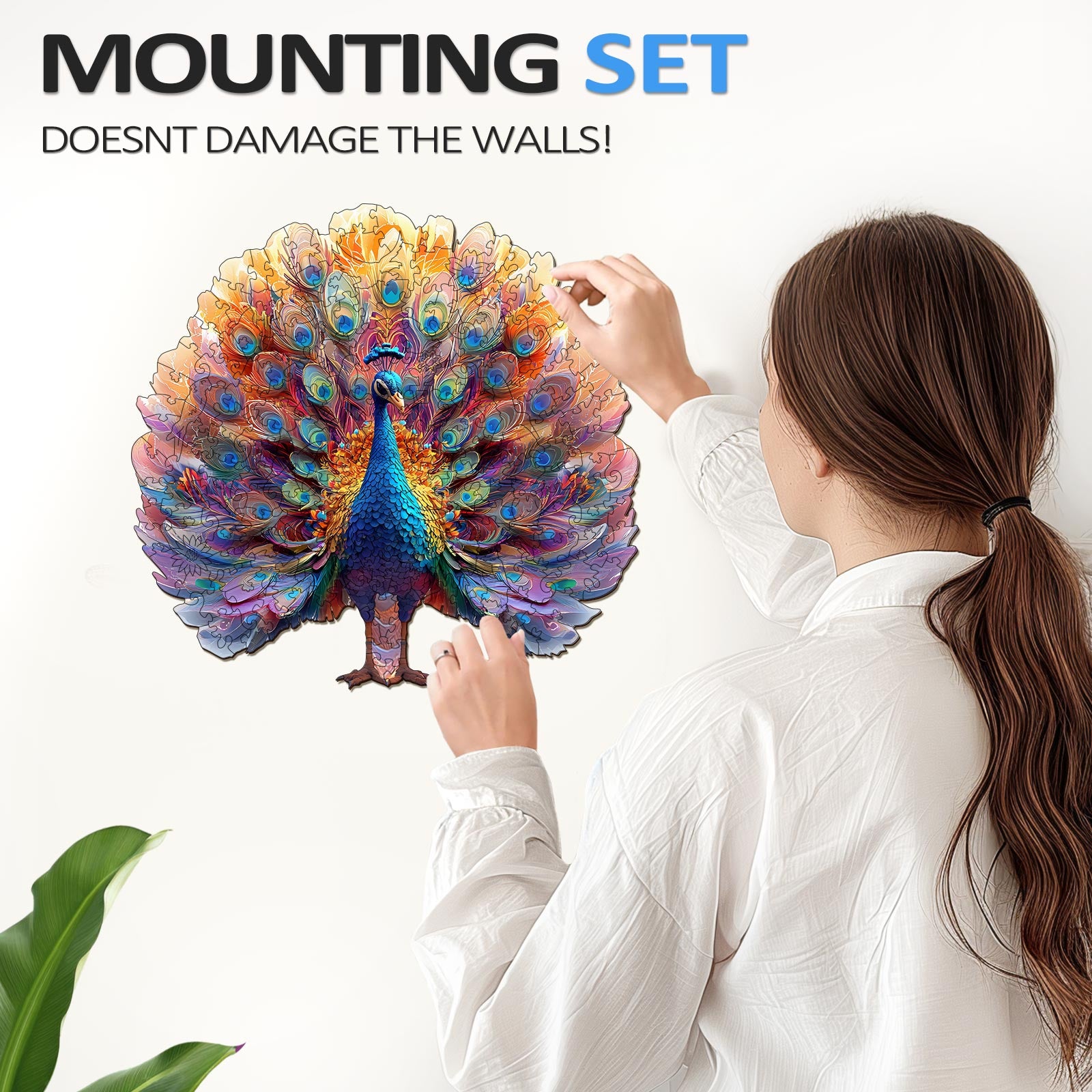 Person applying a striking peacock wall art with a mounting set that doesn’t damage walls.