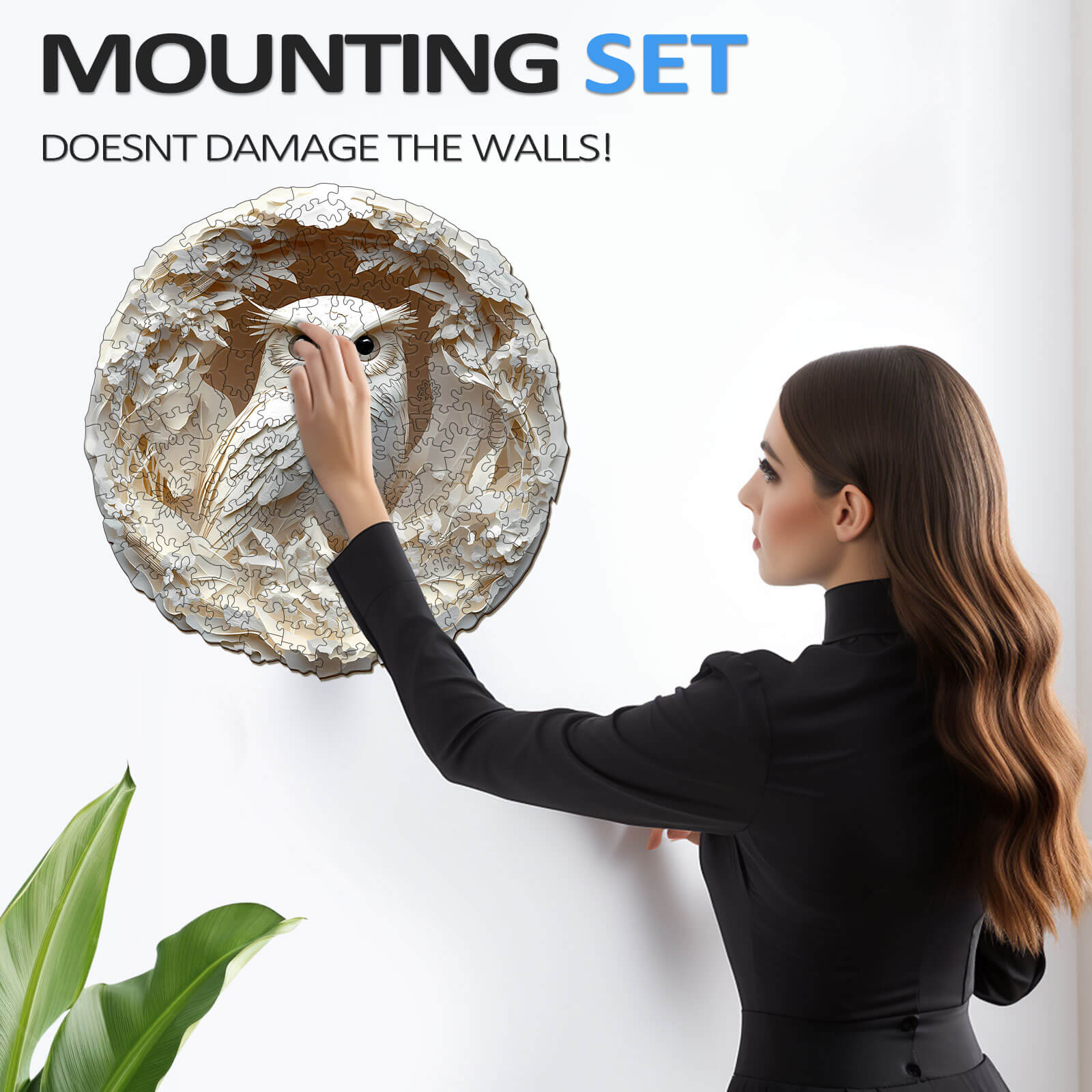 Woman mounting a 3D Paper Carved Owl puzzle on the wall without damaging it, showcasing a unique decor solution.
