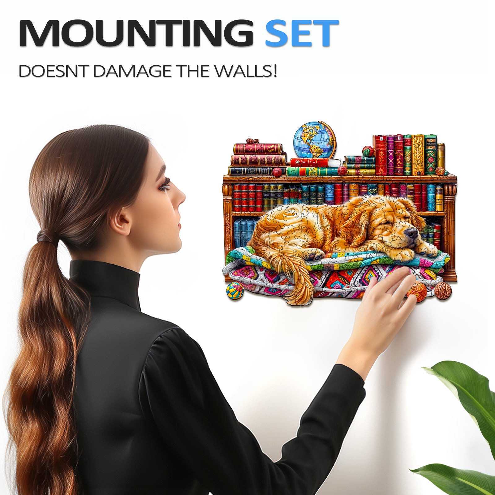 Woman mounting a wooden jigsaw puzzle of a sleeping golden retriever on a wall with bookshelves.