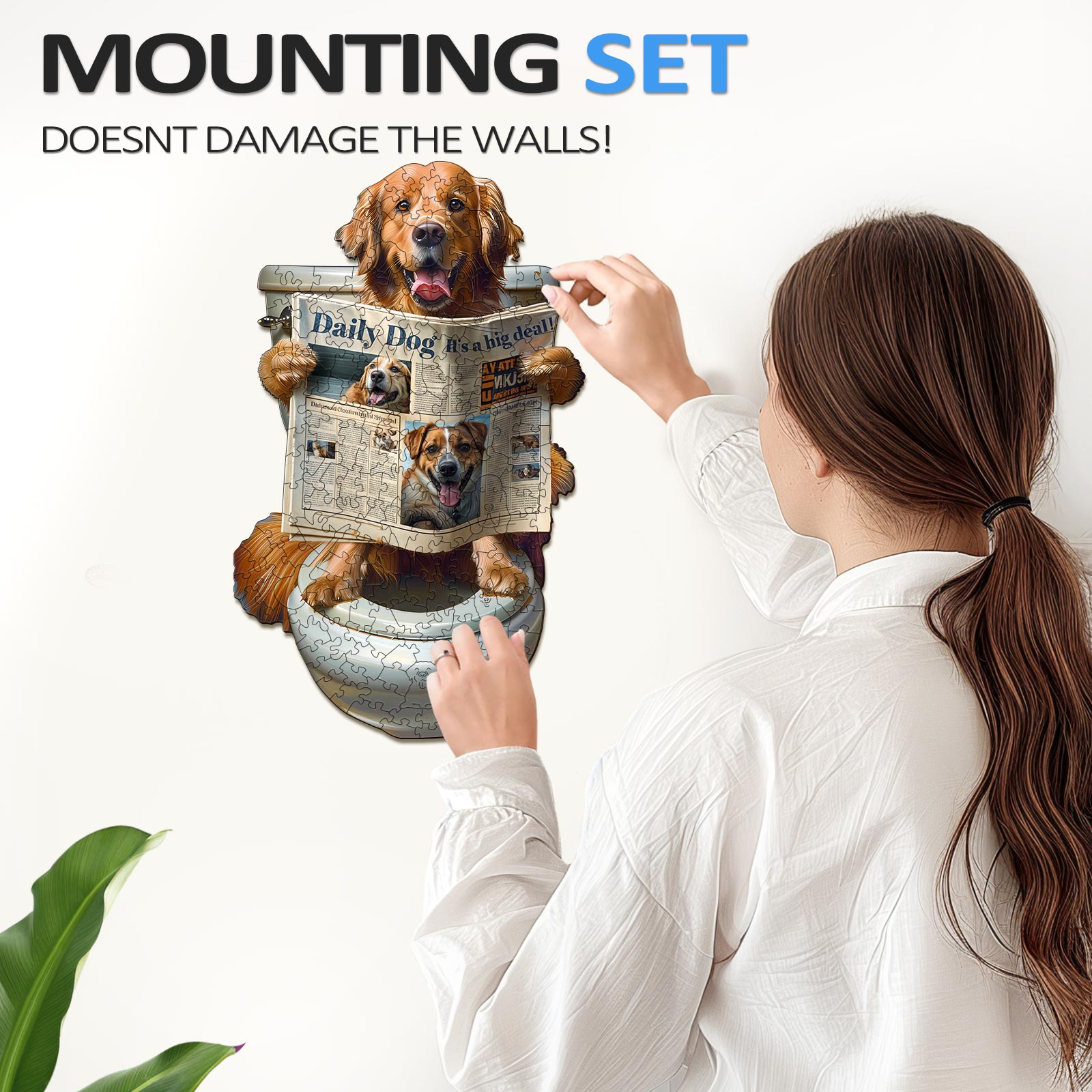 Woman applying a dog-themed wall art with a mounting set that doesn't damage walls.