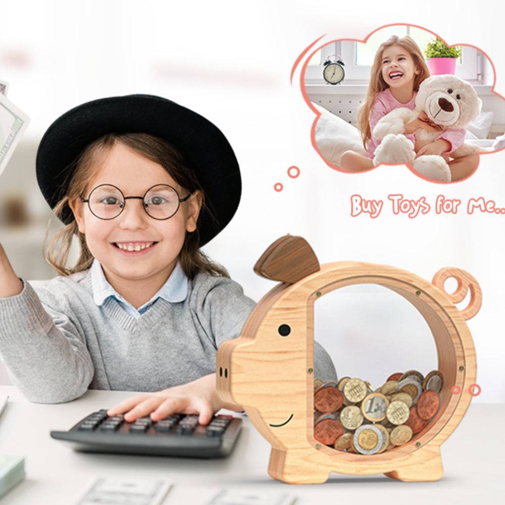 Smiling girl with glasses using calculator beside a cute wooden piggy bank filled with coins.