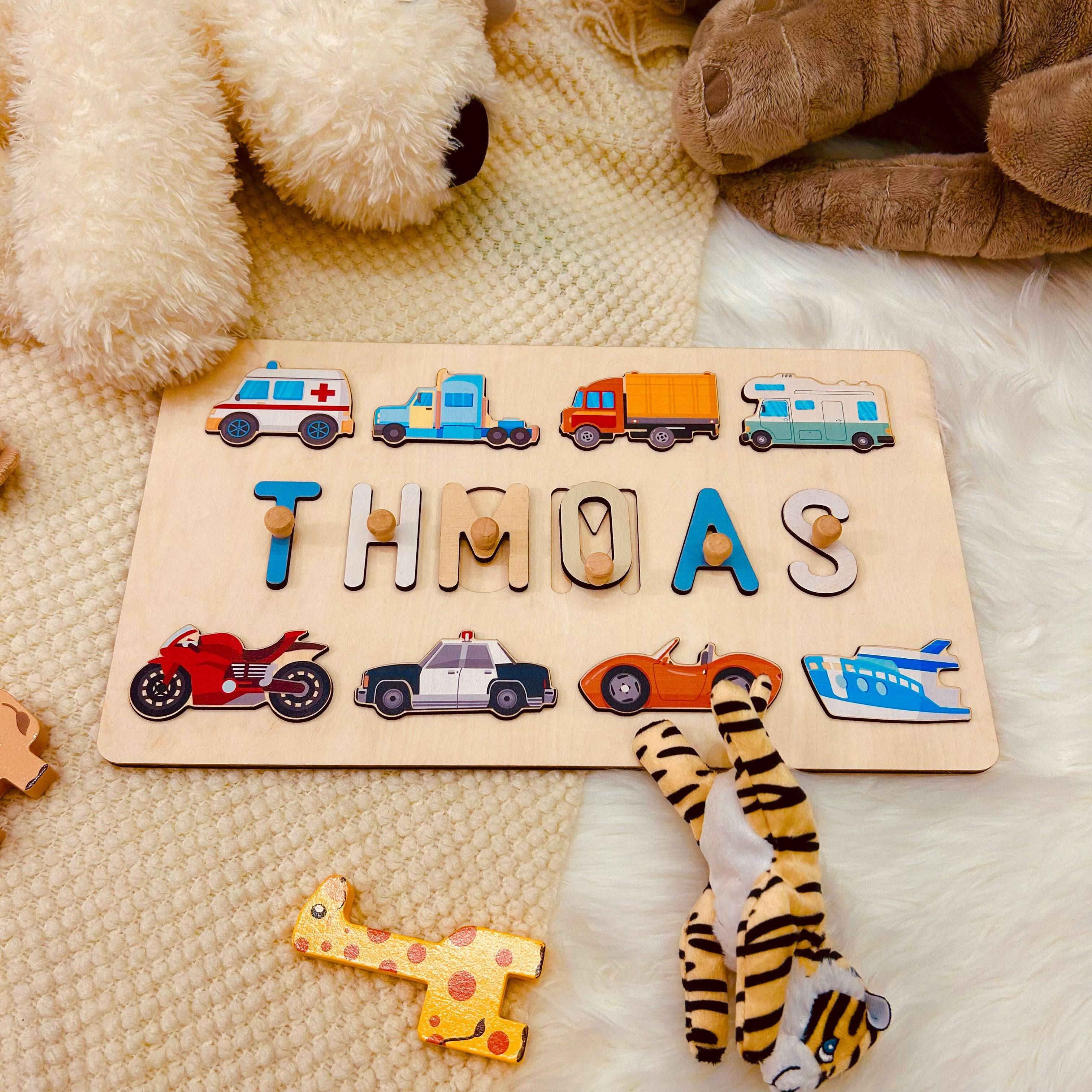 Personalized wooden baby name puzzle featuring the name 'THOMAS' with colorful traffic icons.