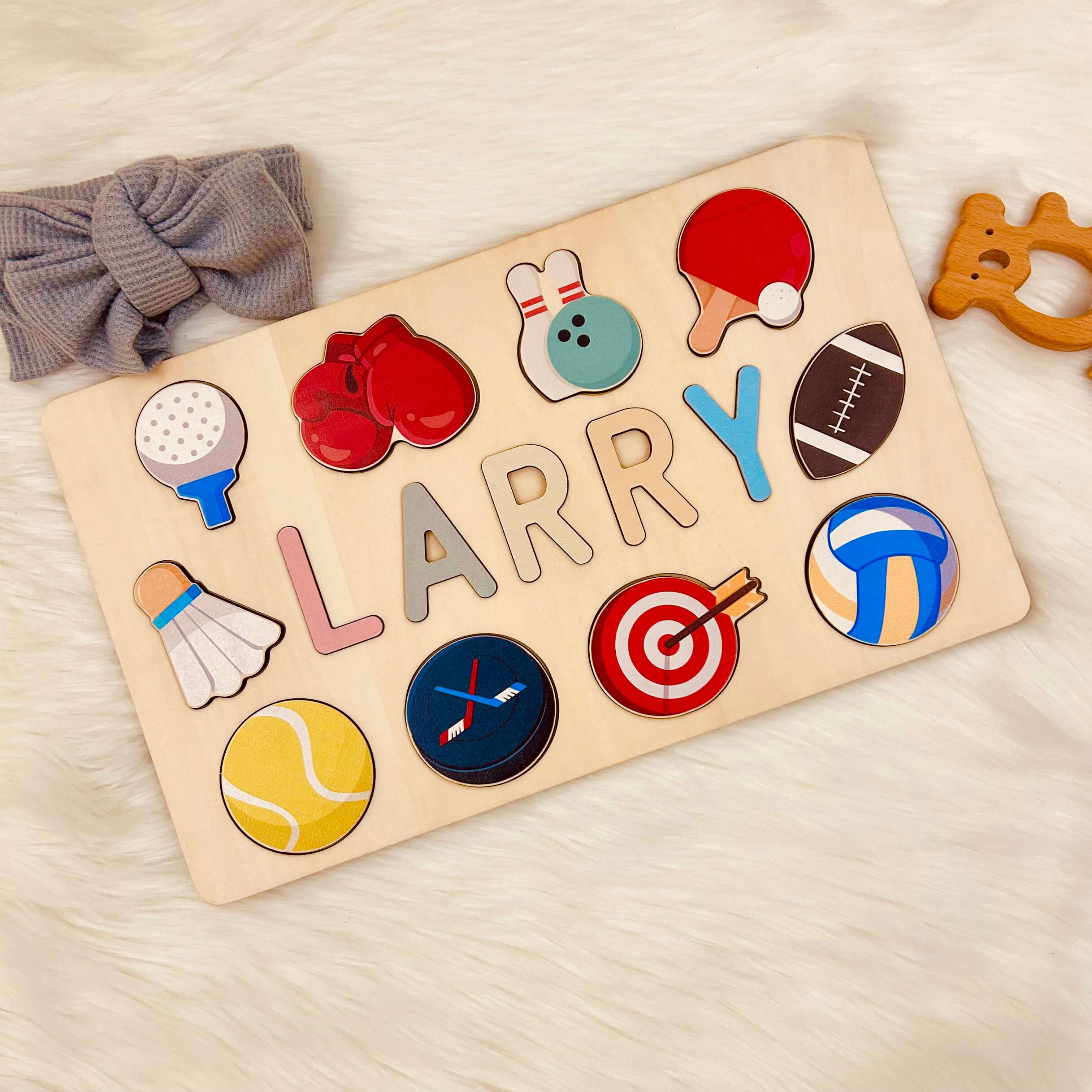 Personalized wooden baby name puzzle featuring the name 'Larry' with colorful sports icons.