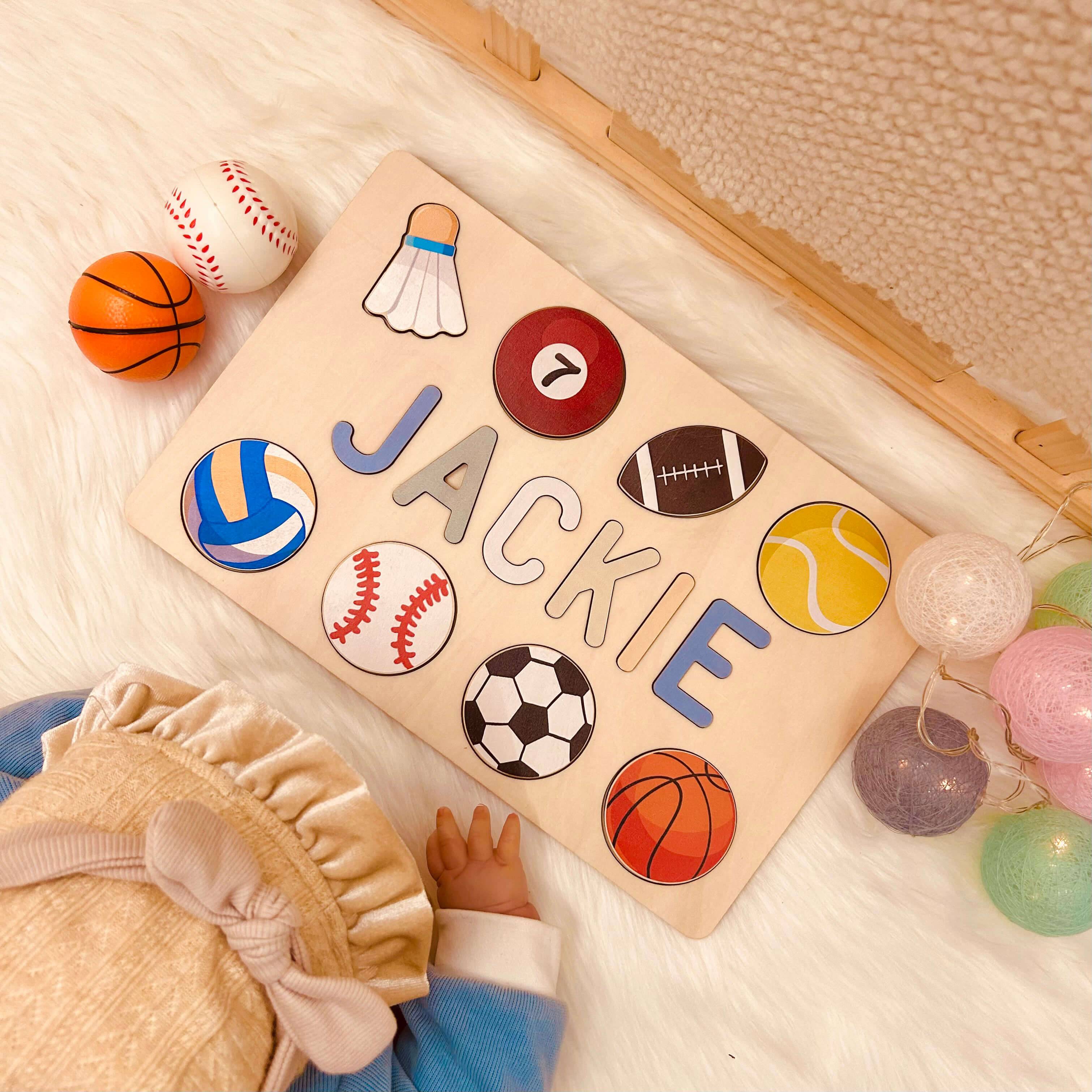 Personalized wooden baby name puzzle 'Jackie' with colorful sports icons, ideal for educational play.