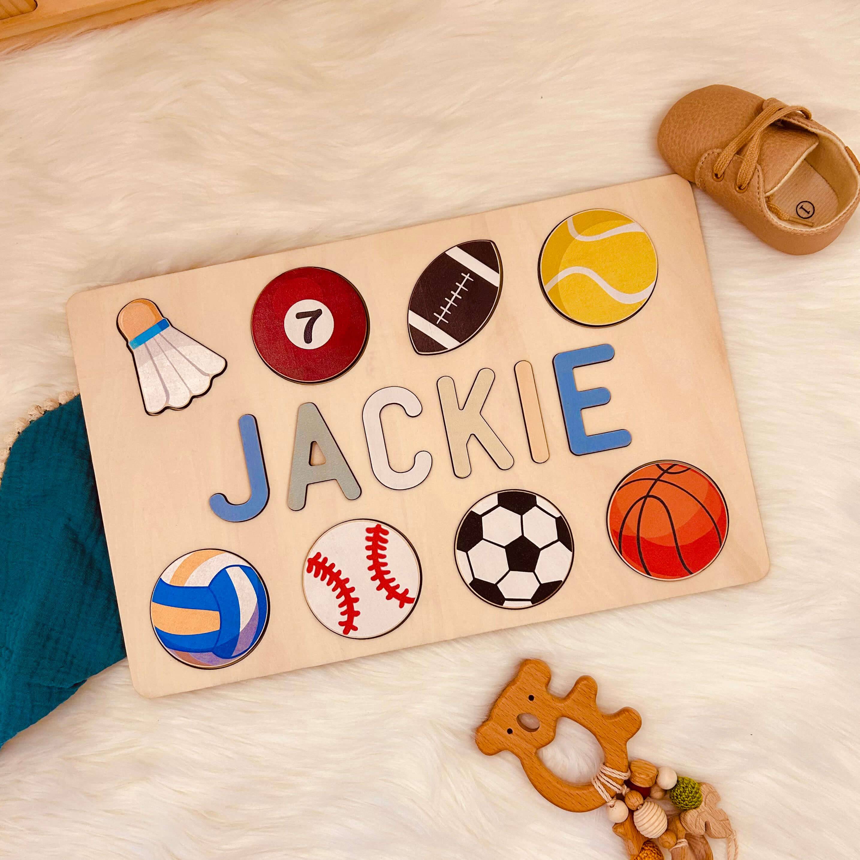 Personalized wooden baby name puzzle for Jackie featuring colorful sports icons and non-toxic materials.