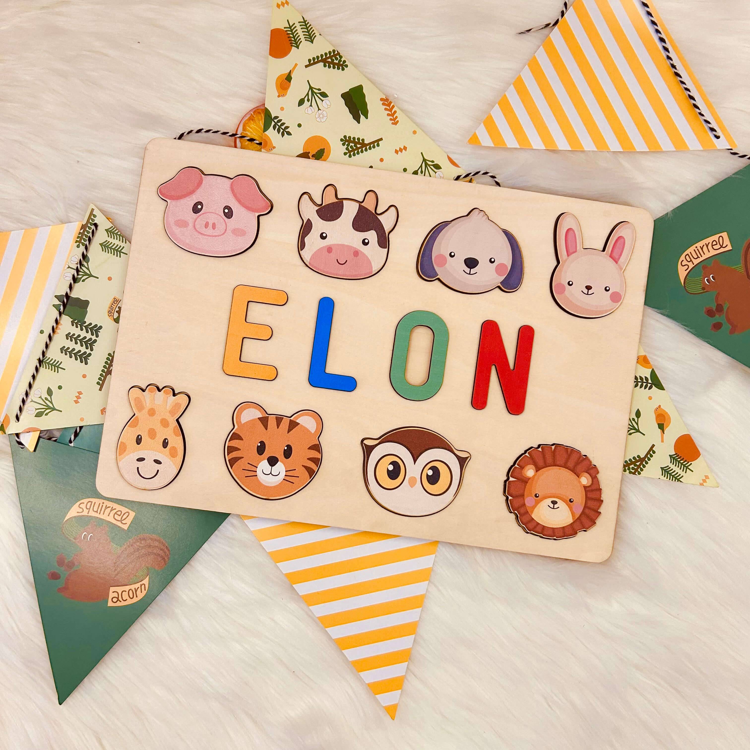 Personalized wooden baby name puzzle with animals, featuring colorful letters and cute character icons, ideal for toddlers.