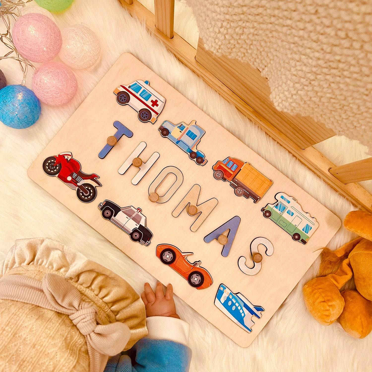 Personalized wooden name puzzle featuring vehicles, spelling 'THOMAS', perfect for kids' playroom decor.
