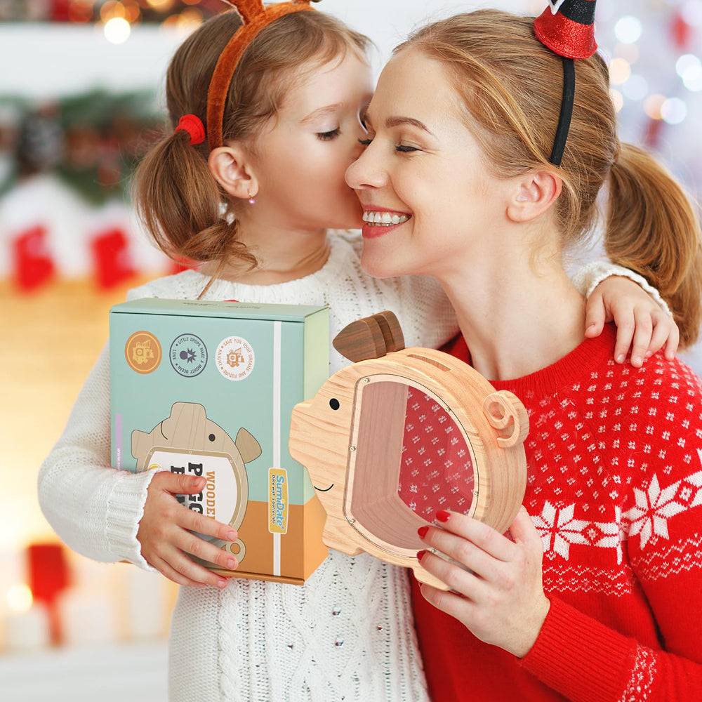 Mom and child sharing joy with a personalized wooden piggy bank during the holidays, celebrating savings and family moments.