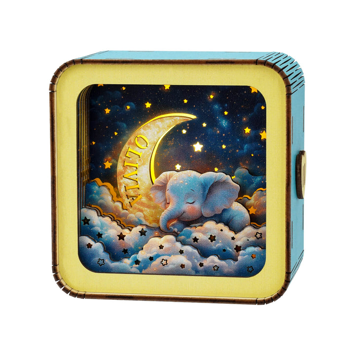 Dream Elephant 3D wooden puzzle night light featuring a cozy elephant with moon and stars in a decorative design.