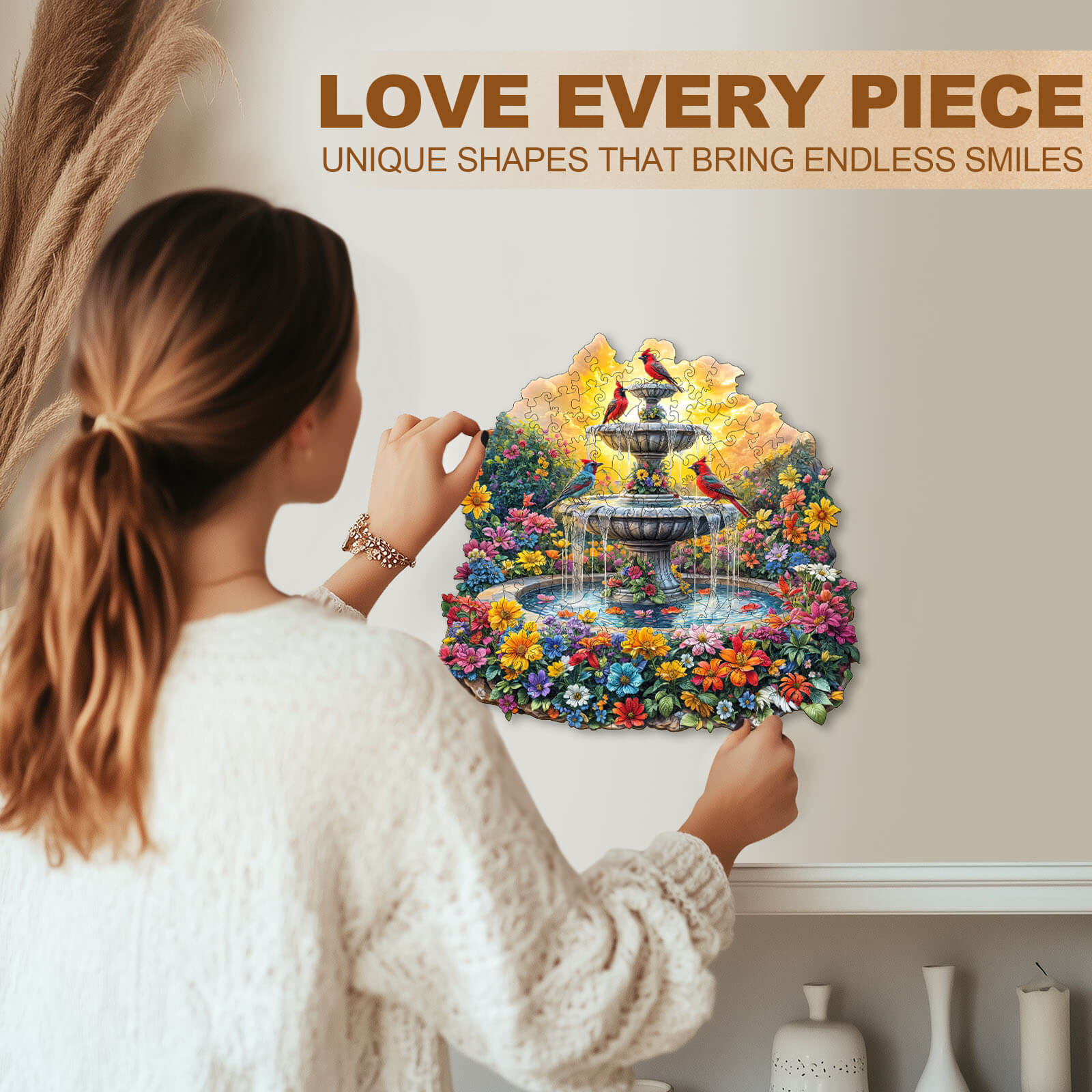 Woman assembling Songbird’s Garden wooden jigsaw puzzle featuring a colorful fountain and flowers.
