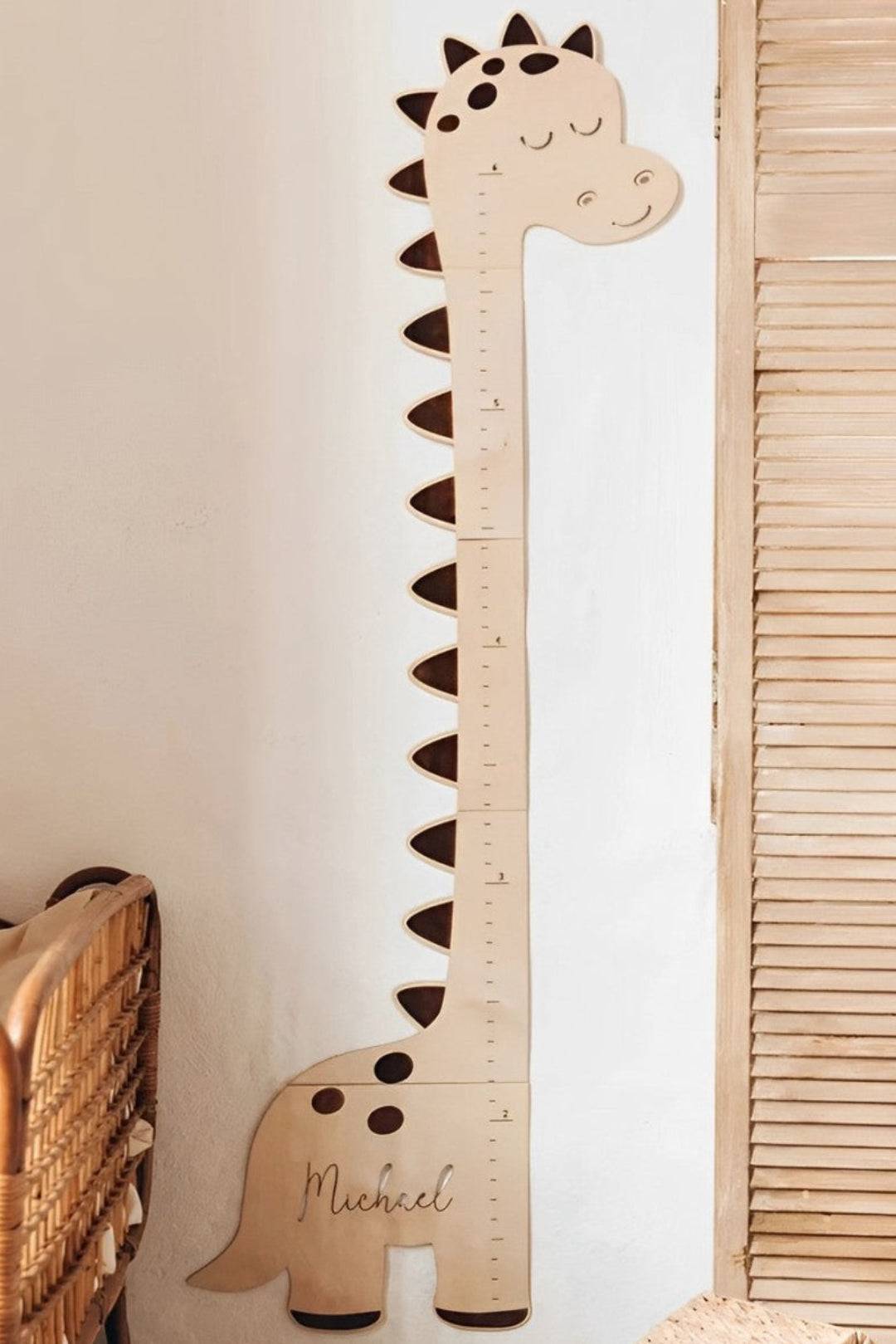 Personalized wooden dinosaur growth chart height ruler for kids with cheerful design.