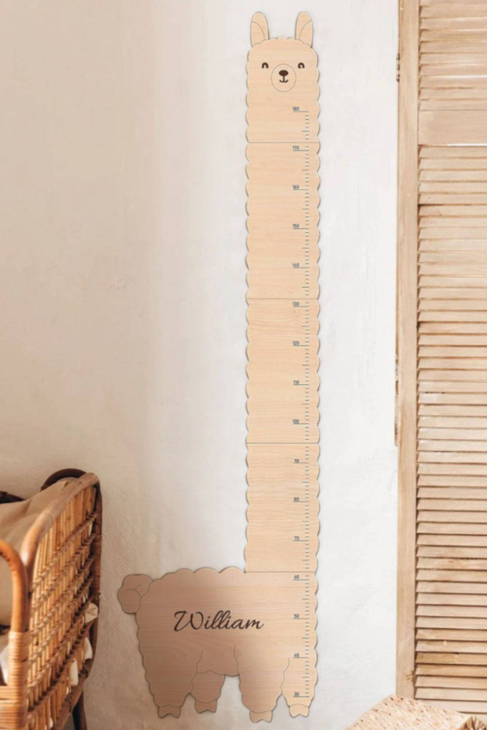 Personalized wooden alpaca height chart ruler for kids, measuring growth with a cute design in a child's room.
