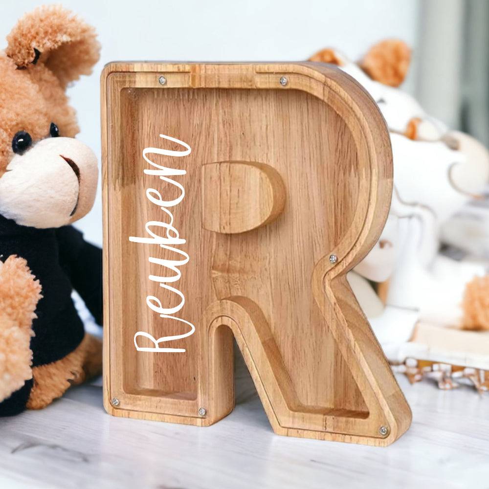 Personalized wooden letter 'R' piggy bank for kids, promoting financial awareness and savings.