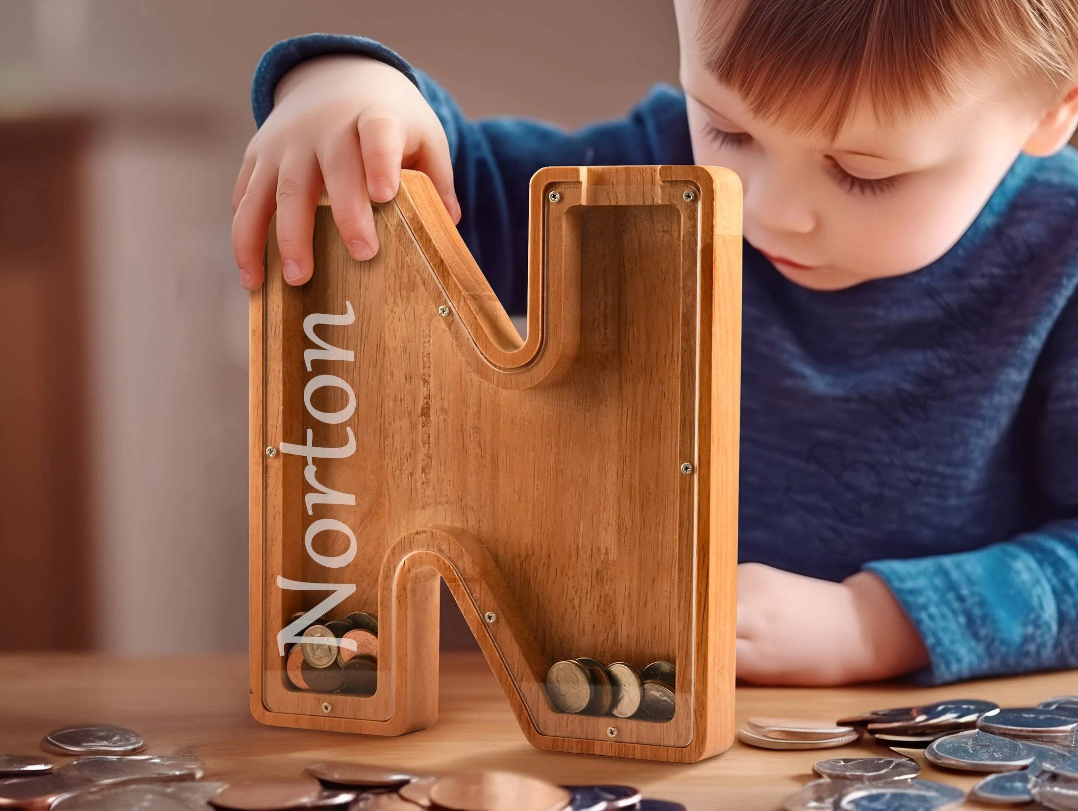 Child inserting coins into personalized wooden letter piggy bank, promoting savings awareness.