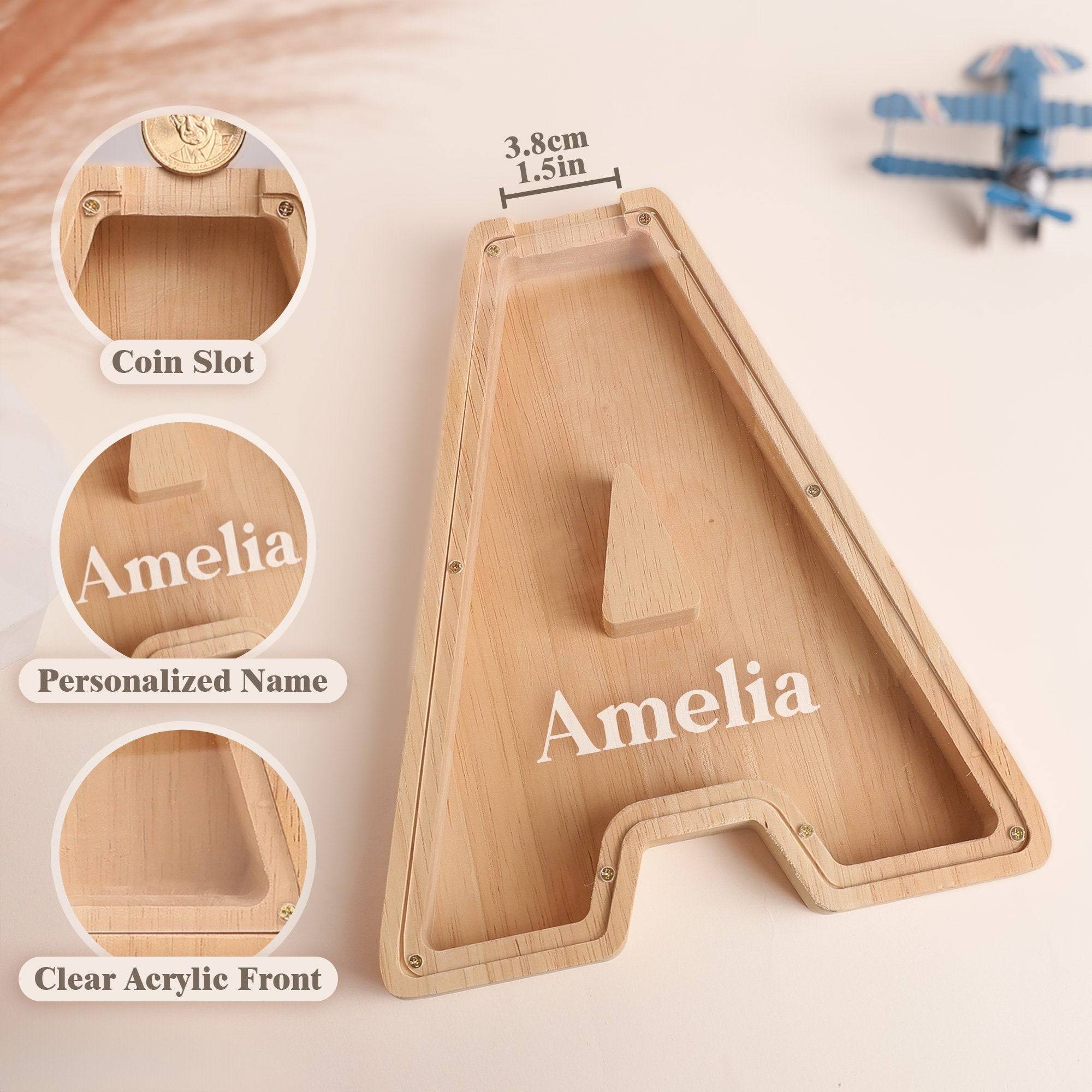 Personalized wooden letter piggy bank for kids, featuring a coin slot and acrylic front with the name Amelia.