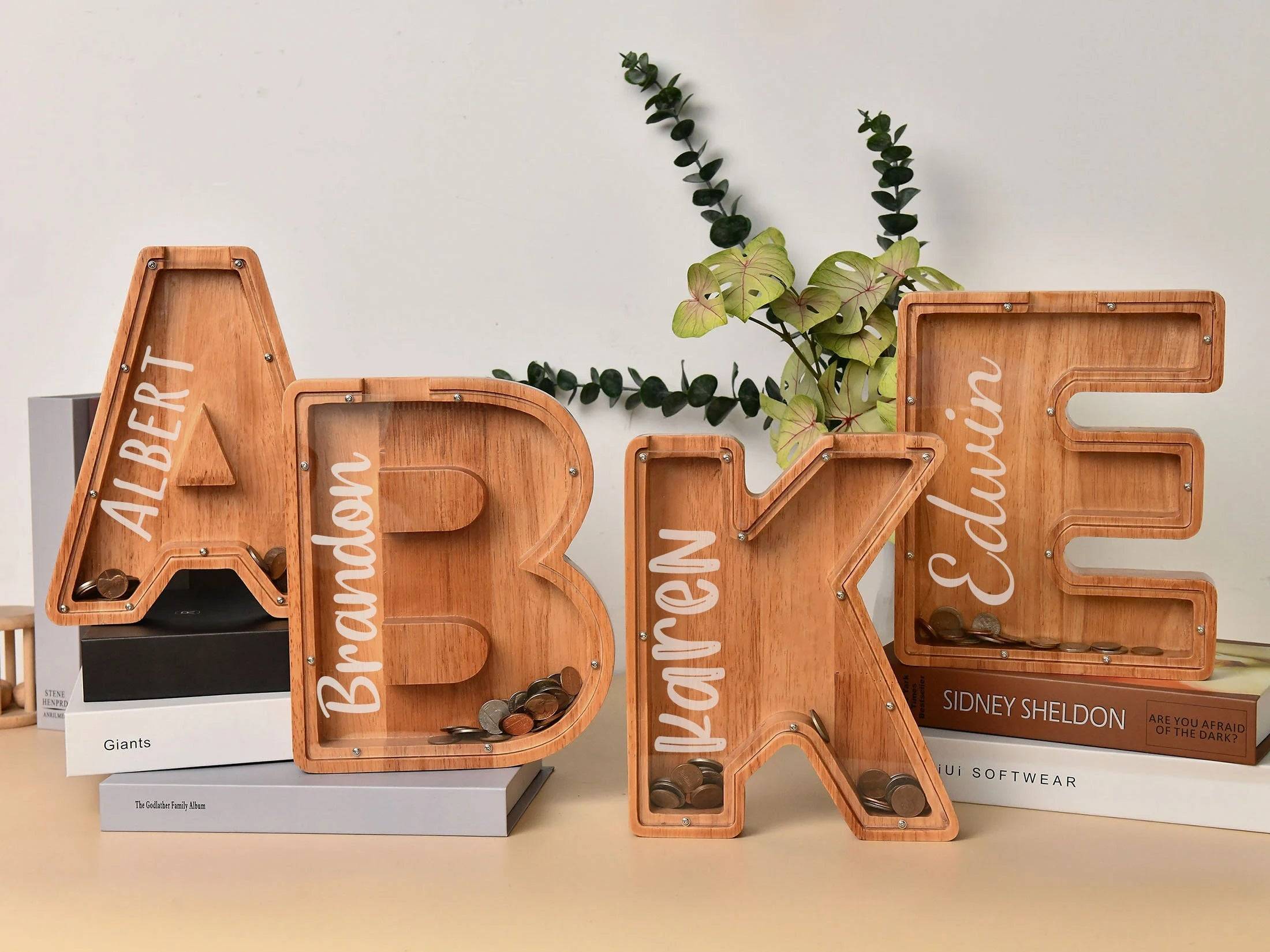 Personalized wooden letter piggy banks for kids with names, perfect for teaching financial awareness and savings.