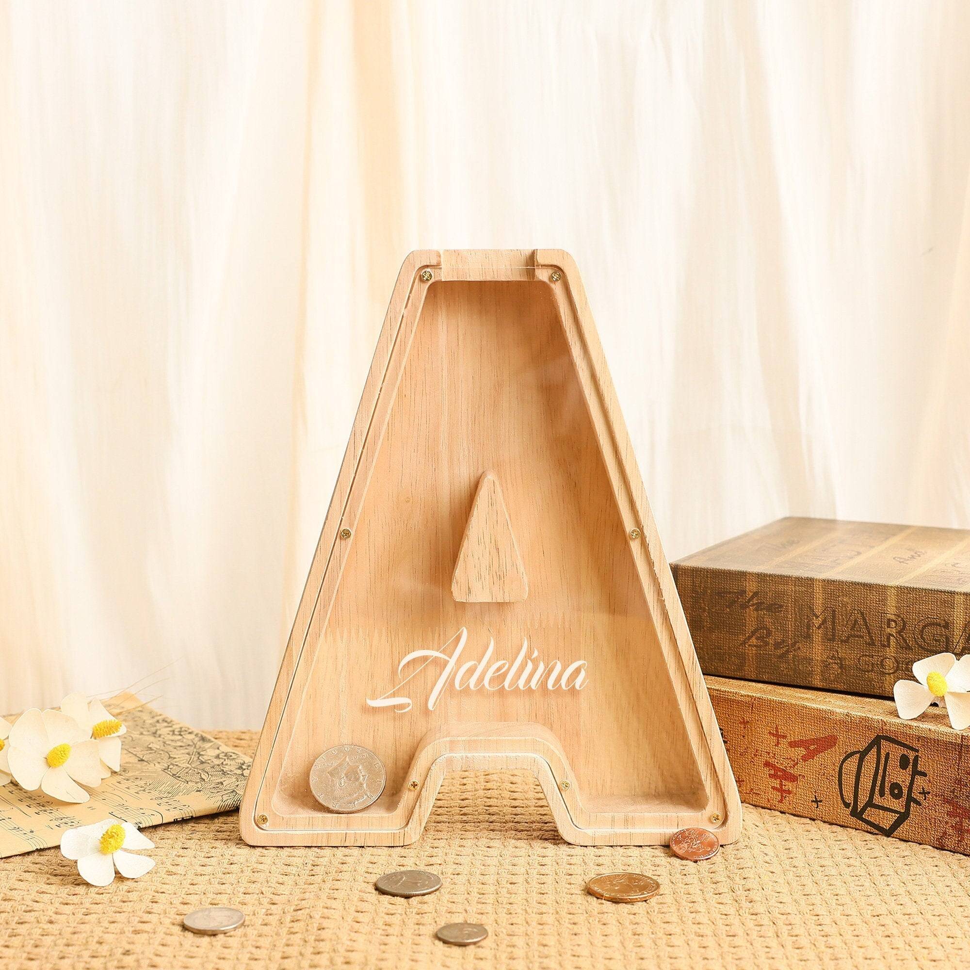 Custom wooden letter piggy bank shaped like 'A', personalized for kids, promoting savings and financial awareness.